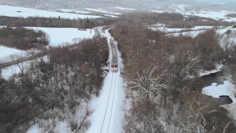 Aerial-View-Over-Train-Travelling-Through-Winter-Snow-Landscape-At-Tatra-National-Park