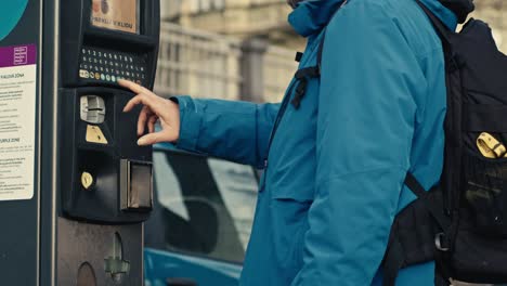 Man-paying-ticket,-parking-machine-on-street-in-Prague,-easy-way-to-park-anywhere