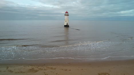 Point-of-Ayr-Lighthouse-From-The-Beach-During-High-Tide-In-Talacre,-Wales,-United-Kingdom