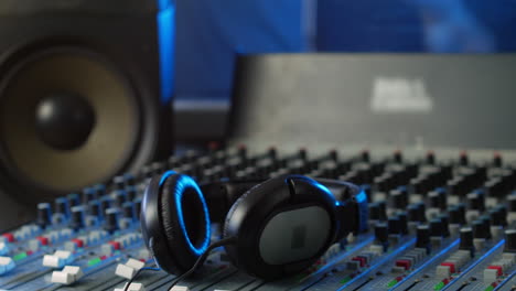 Headphones-on-a-mixing-desk-in-an-audio-recording-studio