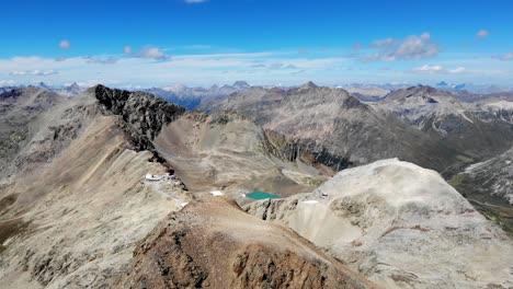 Aerial-flyover-around-Fuorcla-Trovat-peak-at-Diavolezza-in-Engadin,-Switzerland-with-views-of-Pers-glacier-and-other-peaks-of-the-Swiss-Alps-around-St