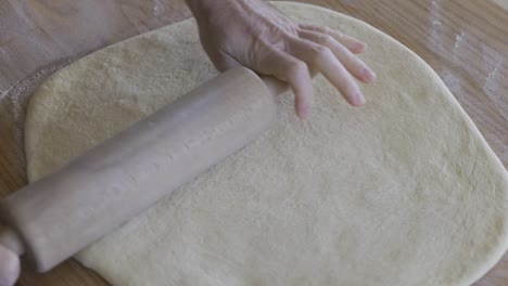 Rolling-out-dough-while-making-donuts
