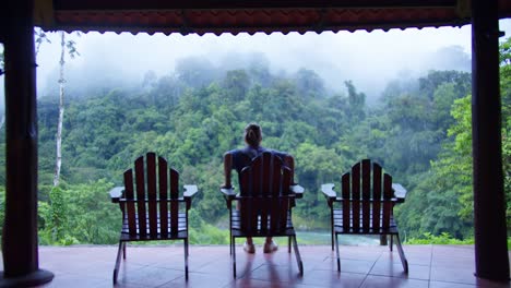 Man-Takes-Pictures-on-Costa-Rica-Cloud-Rainforest-Resort-Lodge-Balcony