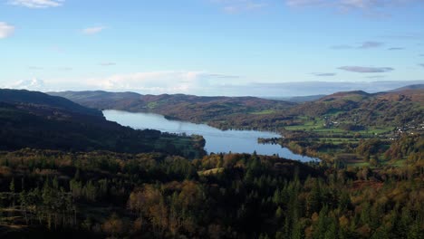 Lake-District-Unesco-National-Park-Aerial-drone-flight-over-autumnal-woodland-and-coniston-water-in-early-morning-Autumn-2021