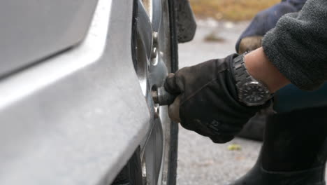 Close-up-of-unrecognizable-person-hands-changing-season-Tire-at-home