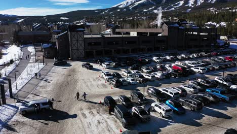 Cars-In-Parking-Spaces-At-Ski-Resort-and-Lodges-In-Snow-During-Winter-In-Steamboat-Springs,-Colorado
