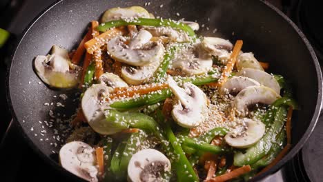 Seasoning-Delicious-Mushrooms-and-Vegetables-Simmering-Frying-Pan