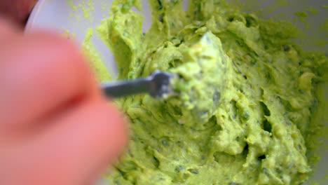 Stirring-Mashed-Avocado-Using-Spoon-In-A-Bowl