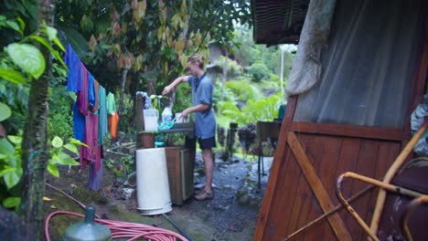 Man-Washing-Rags-and-Laundry-in-Costa-Rica-Outdoors-in-Rainforest