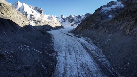 Aerial-flyover-down-to-the-end-of-Forno-glacier-in-Engadin,-Switzerland-shortly-before-sunset