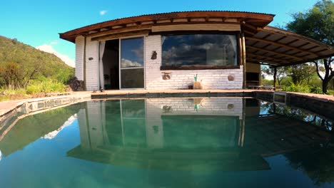 Time-lapse-of-small-house-reflected-on-swimming-pool