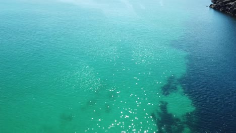 Drone-aerial-over-tropical-blue-water-and-beach-moving-forward