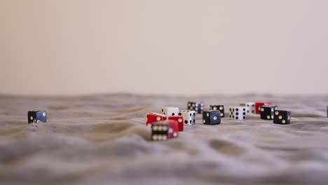 Red-dice-resting-in-a-pile-of-black-and-white-dice