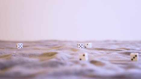 Rolling-six-white-dice-in-extreme-slow-motion-at-eye-level