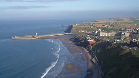 North-York-Moors-Whitby-slow-aerial-decent-over-west-cliff-looking-towards-whitby-pier-and-abbey-in-sunshine-Late-2021-DJI-Inspire-2-Prores