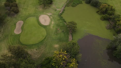 4K-30fps-Aerial-shot-of-golfer-hitting-golf-ball
