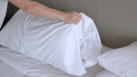 hotel-service-concept,-housekeeper-man-arrange-the-pillow-on-the-bed-with-white-sheet,-make-bed-in-morning