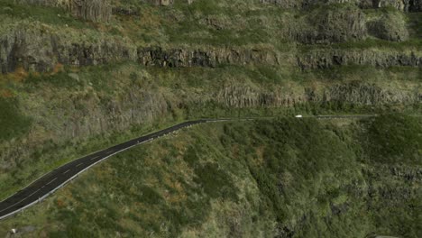 Vehicle-driving-on-high-mountain-road-in-Madeira,-steep-slope,-aerial