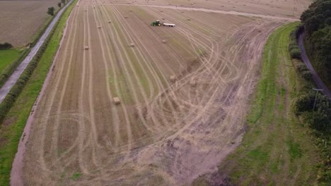 Drone-shot-of-farmland-with-tractor-on-field