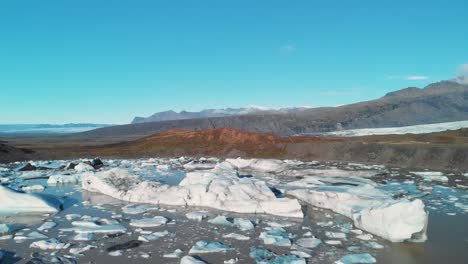 Icebergs-En-Un-Lago-De-Lodo-En-El-Valle-De-Montaña-Del-Glaciar-Skaftafell,-Islandia
