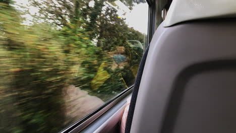 Woman-With-Reflection-On-The-Glass-Window-Wears-Facemask-While-Travelling-By-Train-During-Covid-19-Pandemic