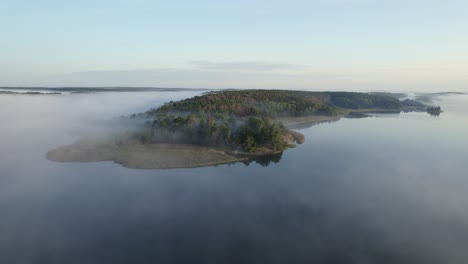 Yttereneby-Natural-Preserve,-Sweden,-aerial-view-above-fog
