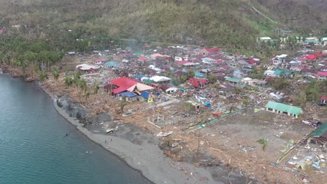 Aerial-drone-footage-of-the-aftermath-of-typhoon-Odette-on-a-coastal-village-in-Southern-Leyte,-Philippines