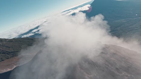 Massive-smoke-clouds-bursting-from-active-volcano-in-Guatemala,-aerial-FPV-shot