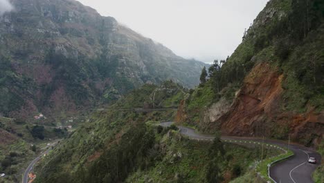 Mountainside-ridge-road-in-wild-natural-Madeira-island,-car-driving-panoramic-route,-aerial