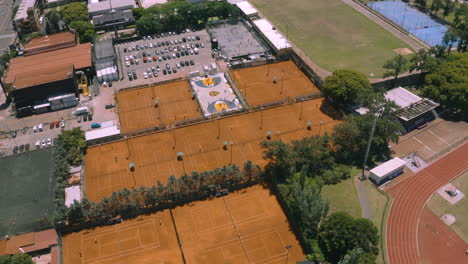 AERIAL---Tennis-courts-at-Club-Ciudad-de-Buenos-Aires,-Argentina,-tilt-down-top-down