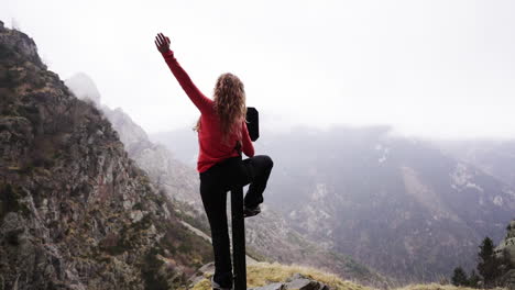 slow-motion-of-successful-young-blond-fitness-woman-releasing-her-happiness-after-reaching-top-of-peak-Mountains-in-long-trekking-outdoor-adventure