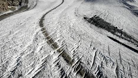Aerial-flyover-over-the-Pers-glacier-near-Diavolezza-in-Engadin,-Swtizerland-with-an-overhead-view-of-the-crevasses