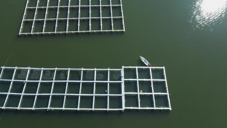Pisciculture-floating-fish-farm-in-Lake-Batur-freshwater,-aerial