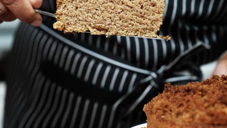 Dishing-up-a-large-slice-of-freshly-baked-moist-homemade-vegan-coffee-cake---slow-motion