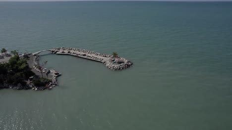 Video-with-a-360º-spiral-drone-over-the-paradisiacal-island-of-Camping-Pa-Emer-in-Karpen,-Albania