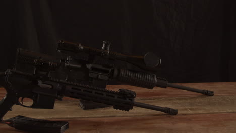 Two-types-of-AR-15-rifles-standing-on-a-wooden-surface
