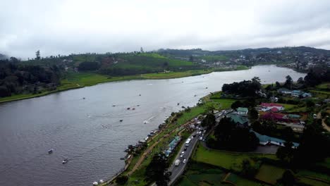 Aerial-Drone-Over-Gregory-Lake-With-Boats-And-Green-Countryside-On-Overcast-Day-In-Nuwara-Eliya-Sri-Lanka