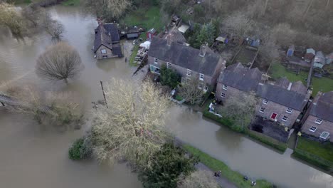 River-Seven-bursting-its-banks-and-flooding-row-of-houses-at-Ironbridge-UK-drone-view