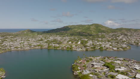 Aerial-pan-of-Kailua-neighborhood-on-the-island-of-Oahu-in-Hawaii-with-Ka'elepulu-pond-and-the-Pacific-ocean-on-the-horizon