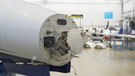 Aeroplane's-Weather-Surveillance-Radar---WSR-visible-due-to-Removed-Nose-Cone-during-Maintenance-in-a-Hangar---Close-Up,-Gimbal-shot