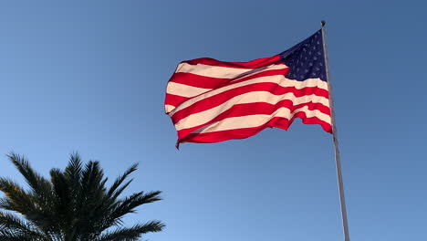 Slow-motion-low-angle-view-of-American-flag-blowing-in-wind