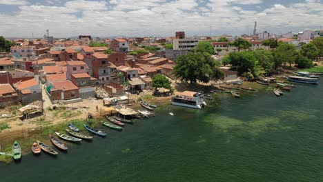 aerial-view-of-fishing-village,-fishing-boats,-houses-on-the-banks-of-the-São-Francisco-River,-border-of-the-states-of-Bahia-and-Pernambuco