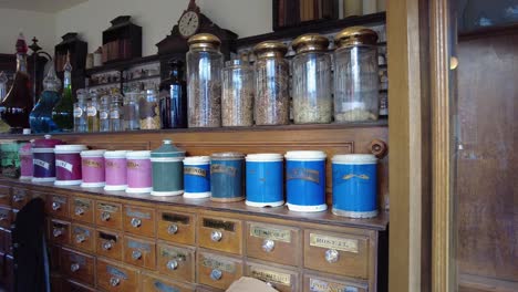 Victorian-era-Apothecary-colourful-jars-lined-up-on-shelves