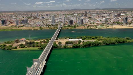 Aerial-view-of-the-bridge-over-the-São-Francisco-River-on-the-border-of-the-states-of-Pernambuco-and-Bahia,-vehicles-transiting-on-the-bridge