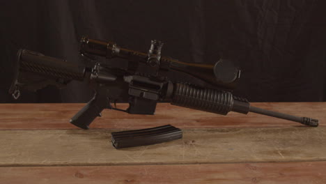 Dolly-in-of-unloaded-AR-15-rifle-with-a-magazine-in-the-foreground