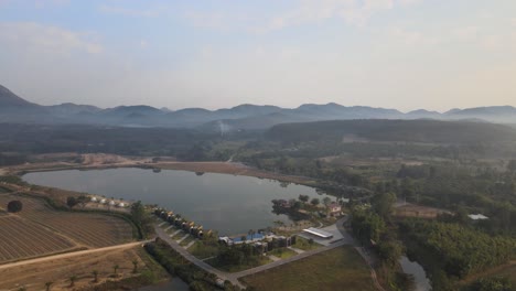 Luftaufnahme-Eines-Sees-Und-Eines-Resorts-Mit-Bergigem-Hintergrund-In-Thailand