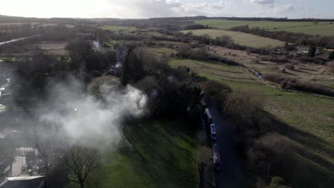 Bonfire-burning-Hungerford-town-and-canal-England-aerial-drone-footage
