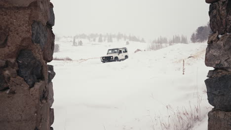 Land-Rover-Defender-D90-Off-Roading-Downhill-on-Snowy-Road-In-Rocky-Mountains-Back-Country-Alpine-Forest-Woods-Near-Nederland-Boulder-Colorado