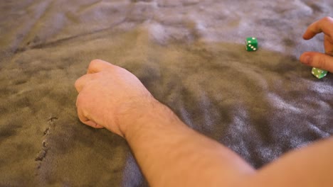 Various-dice,-greens,-limes,-resting-on-green-felt