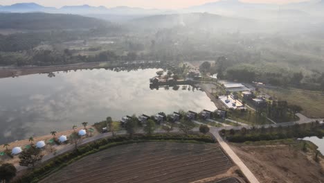 Morning-Mist-Over-a-Lake-with-Scenic-Landscape-from-an-Aerial-View-with-Orbital-Panning-Movement-in-Thailand